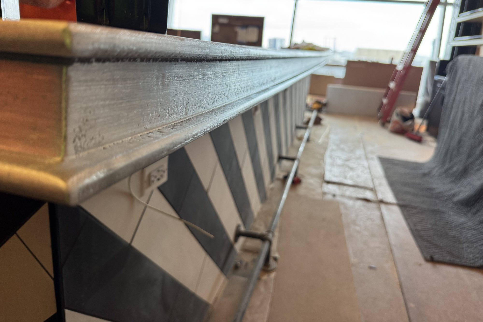 Close-up of the stepped zinc edge profile on a newly installed bar run at Black Tap, JFK Terminal 8, New York