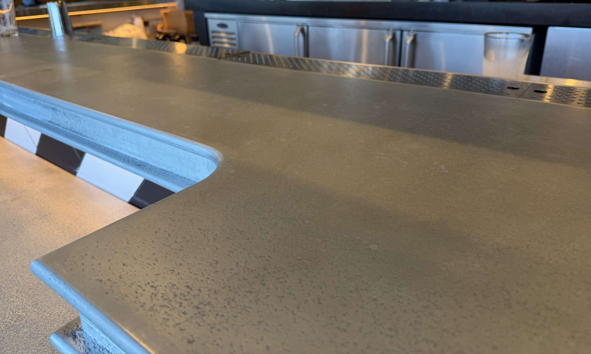 Profiled zinc edge turning an inside corner of the bar at Black Tap, JFK Terminal 8, New York