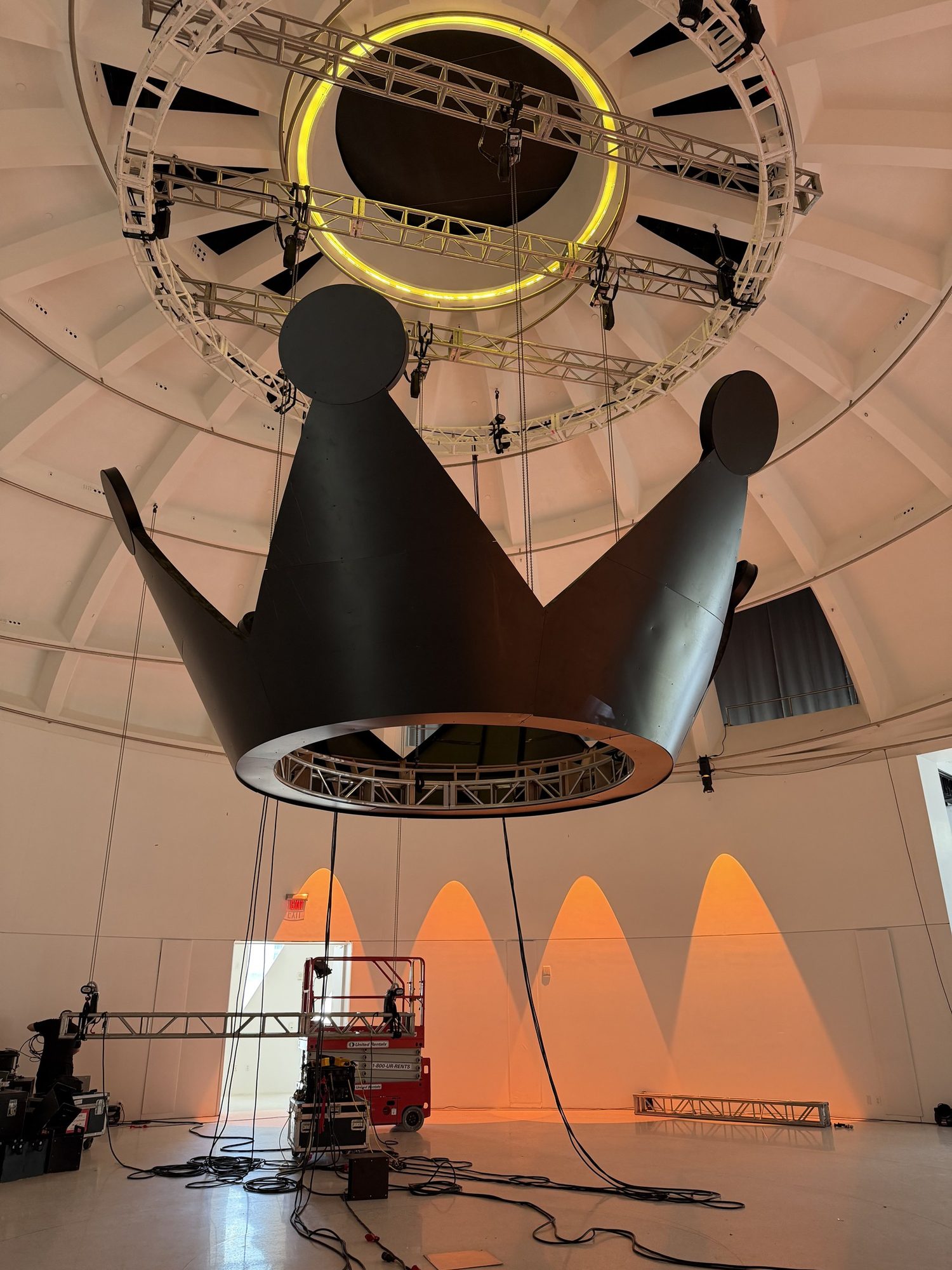 Suspended crown under warm event lighting at Faena Miami Beach
