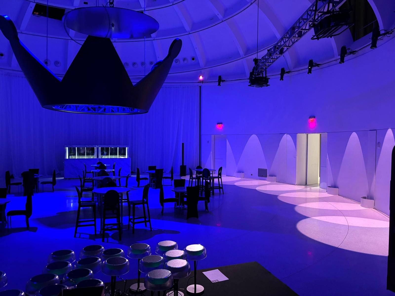 Suspended black crown over the event room under blue lighting at Faena Miami Beach