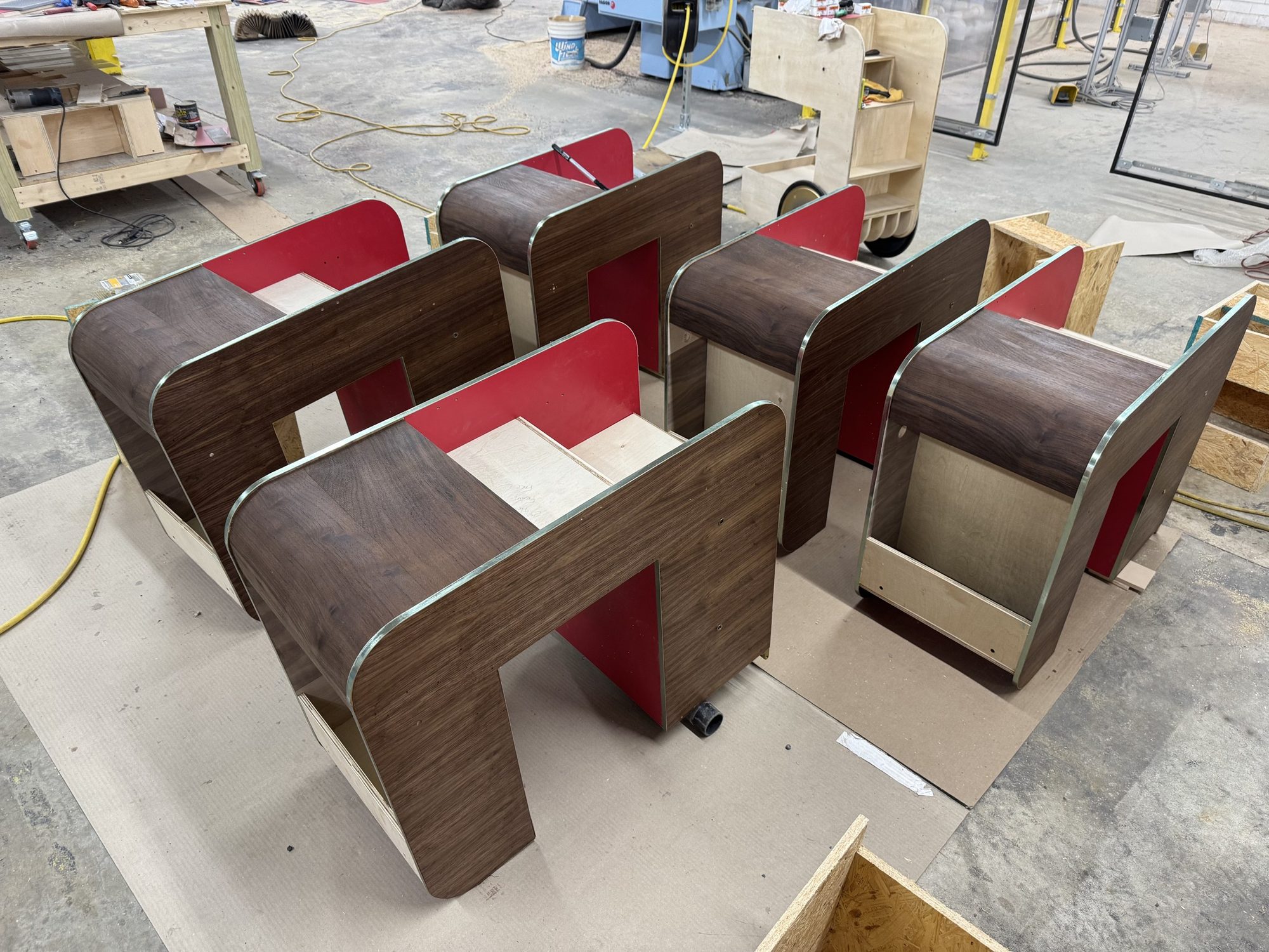 Curved bar-cart shells in walnut-look finish with red interiors