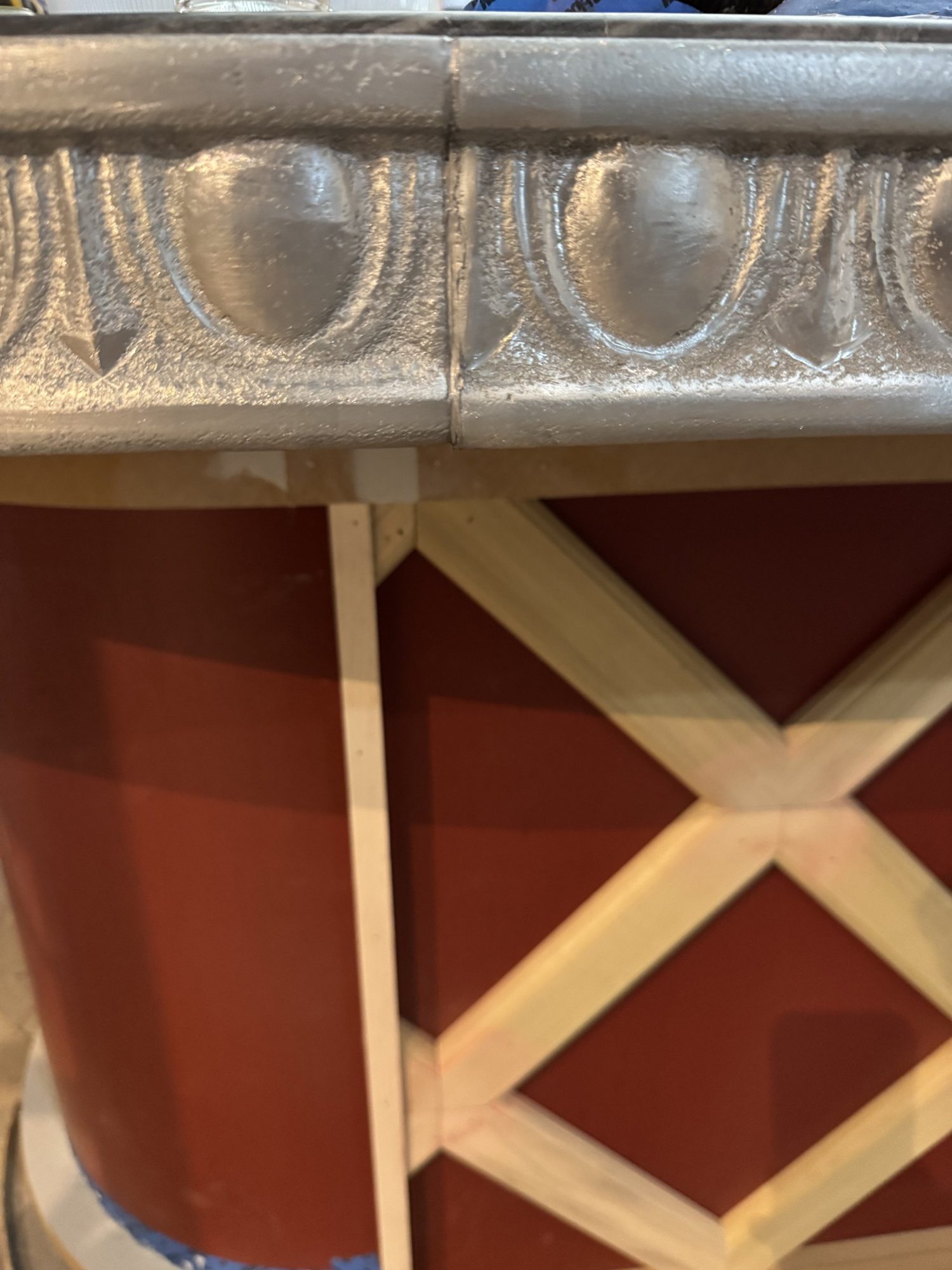 Zinc trim over the red lattice bar front at Restaurant François, Austin