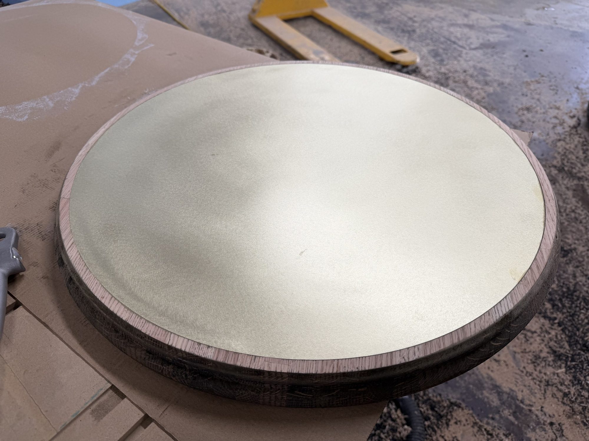 Brass top set into a solid oak table, in the shop, for Sip & Guzzle, West Village, New York