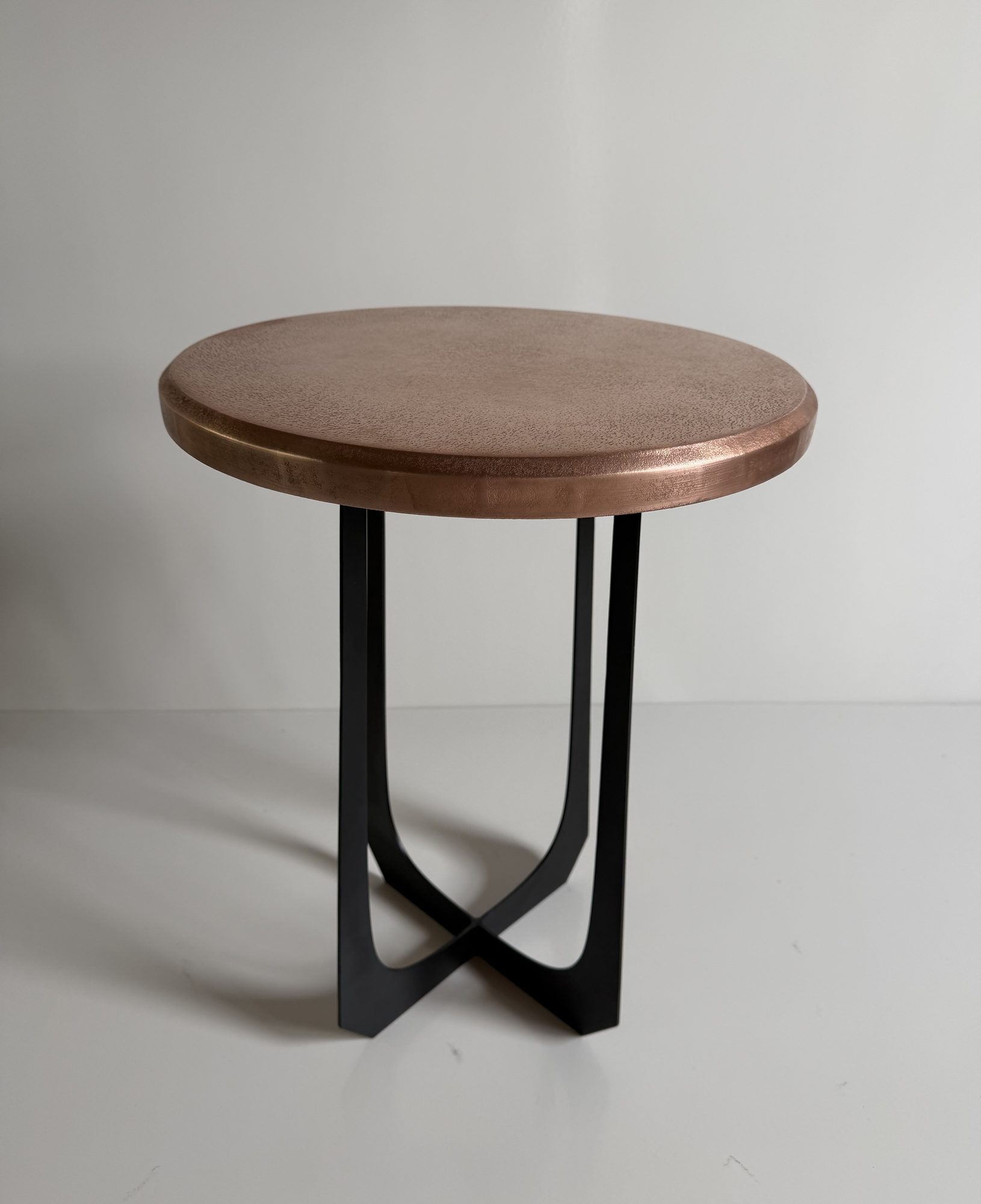 Round copper table top on a black steel base, one of the round copper tables 3 Spark Design made for Uptown Social, Charleston